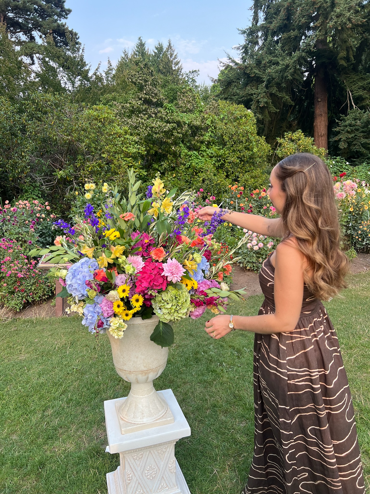 Joanna arranging a colorful floral installation outdoors