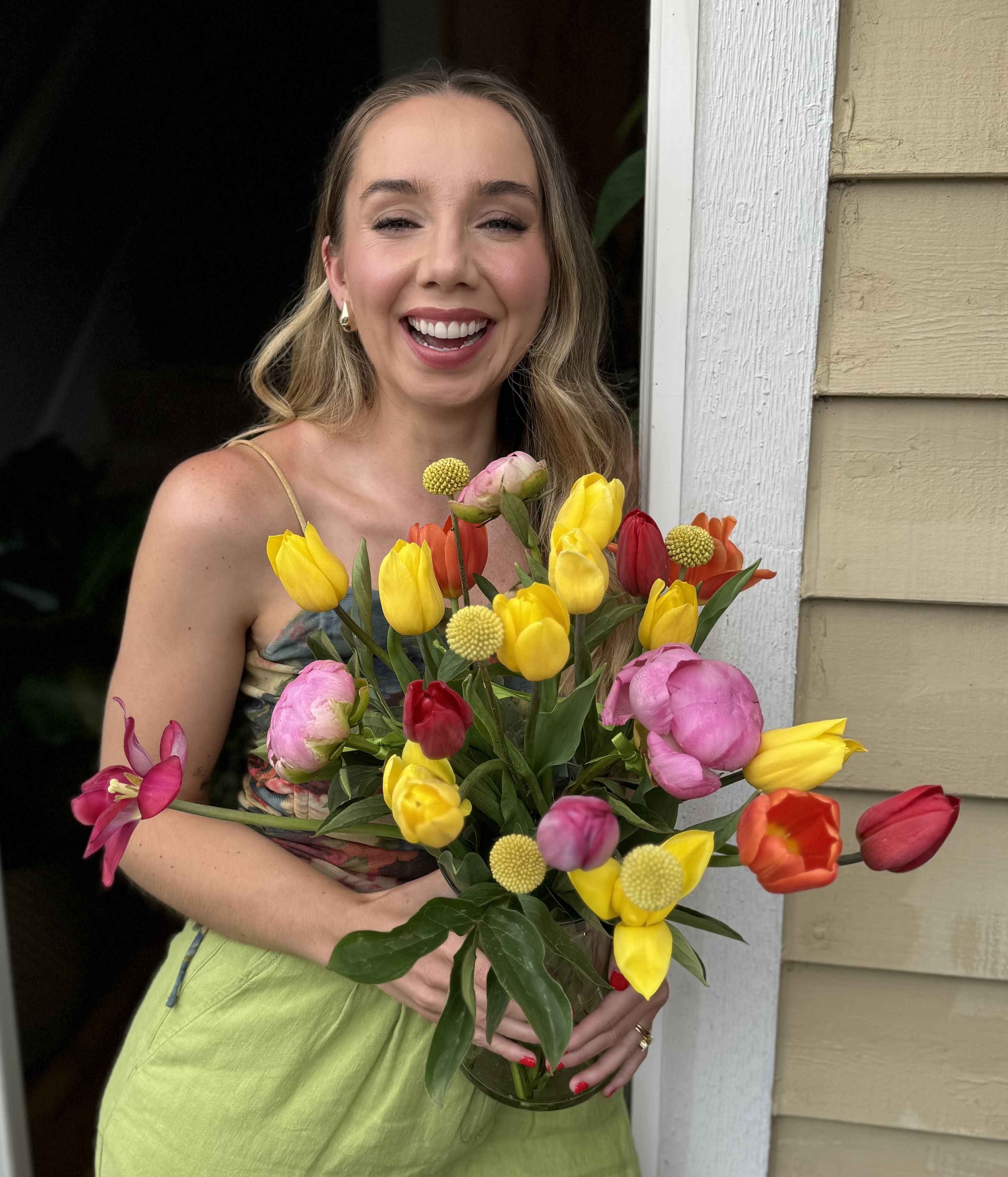 Joanna holding a garden-inspired bouquet in natural light